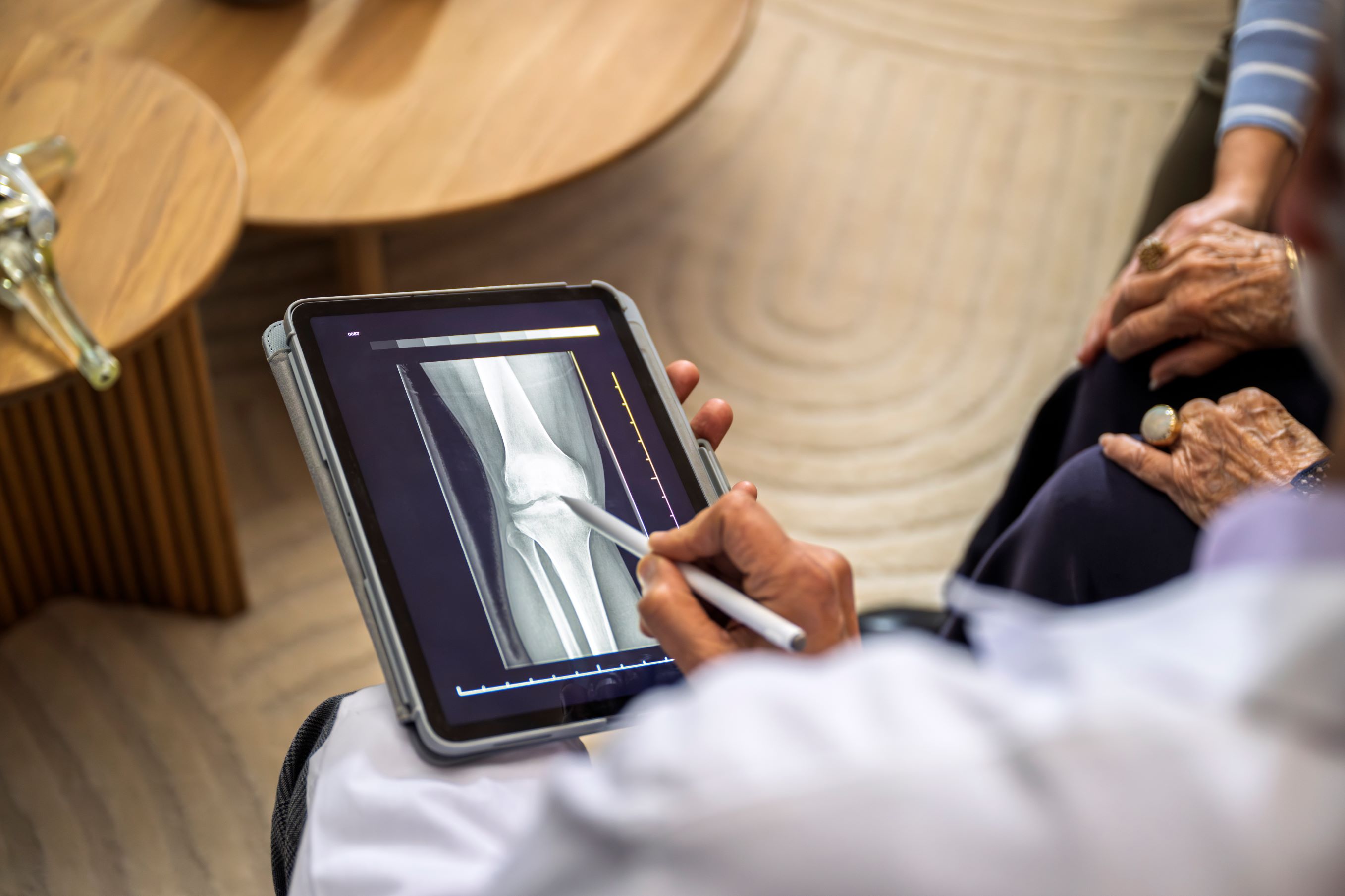 Surgeon holding tablet during a patient consultation